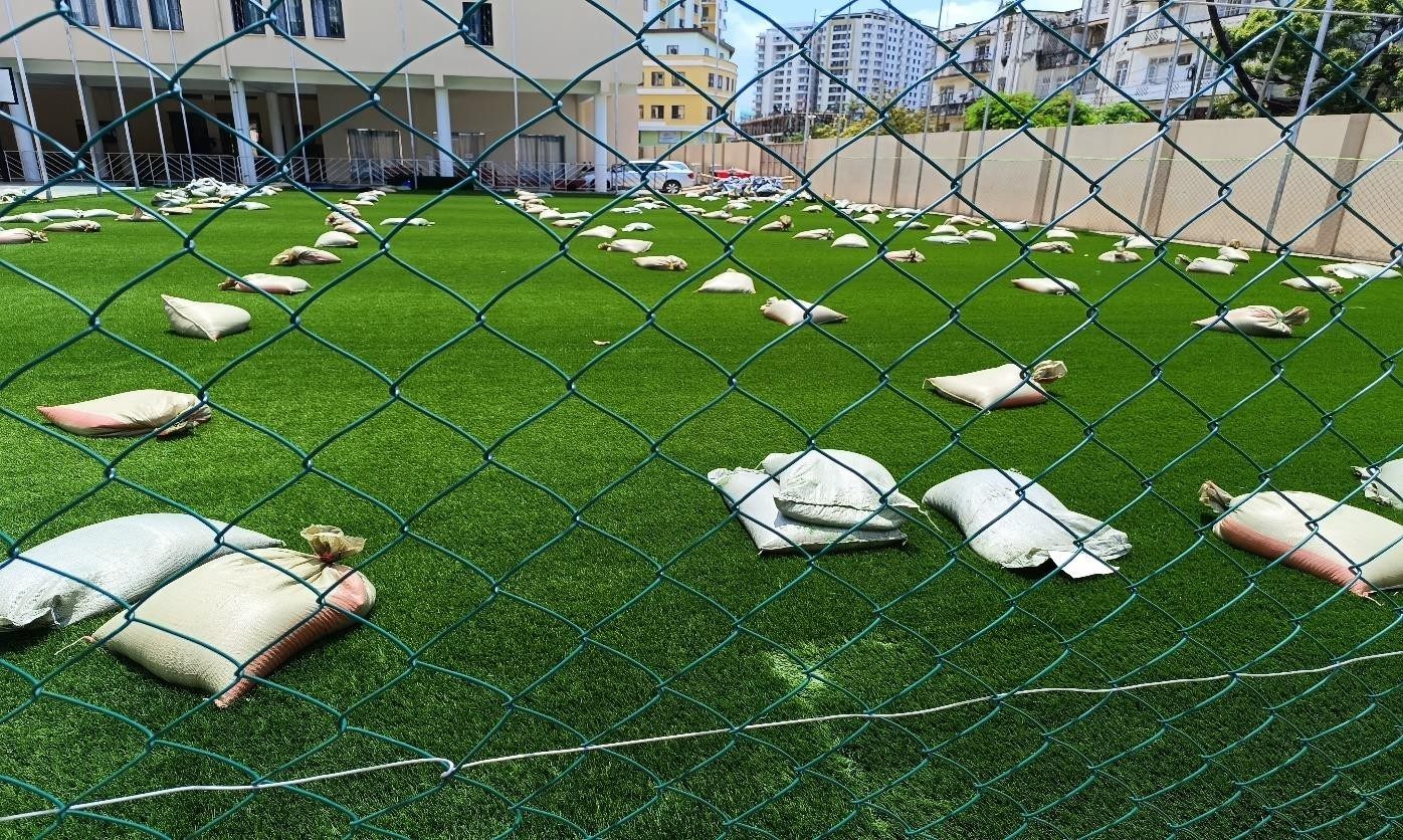Turf pitch behind perimeter fencing